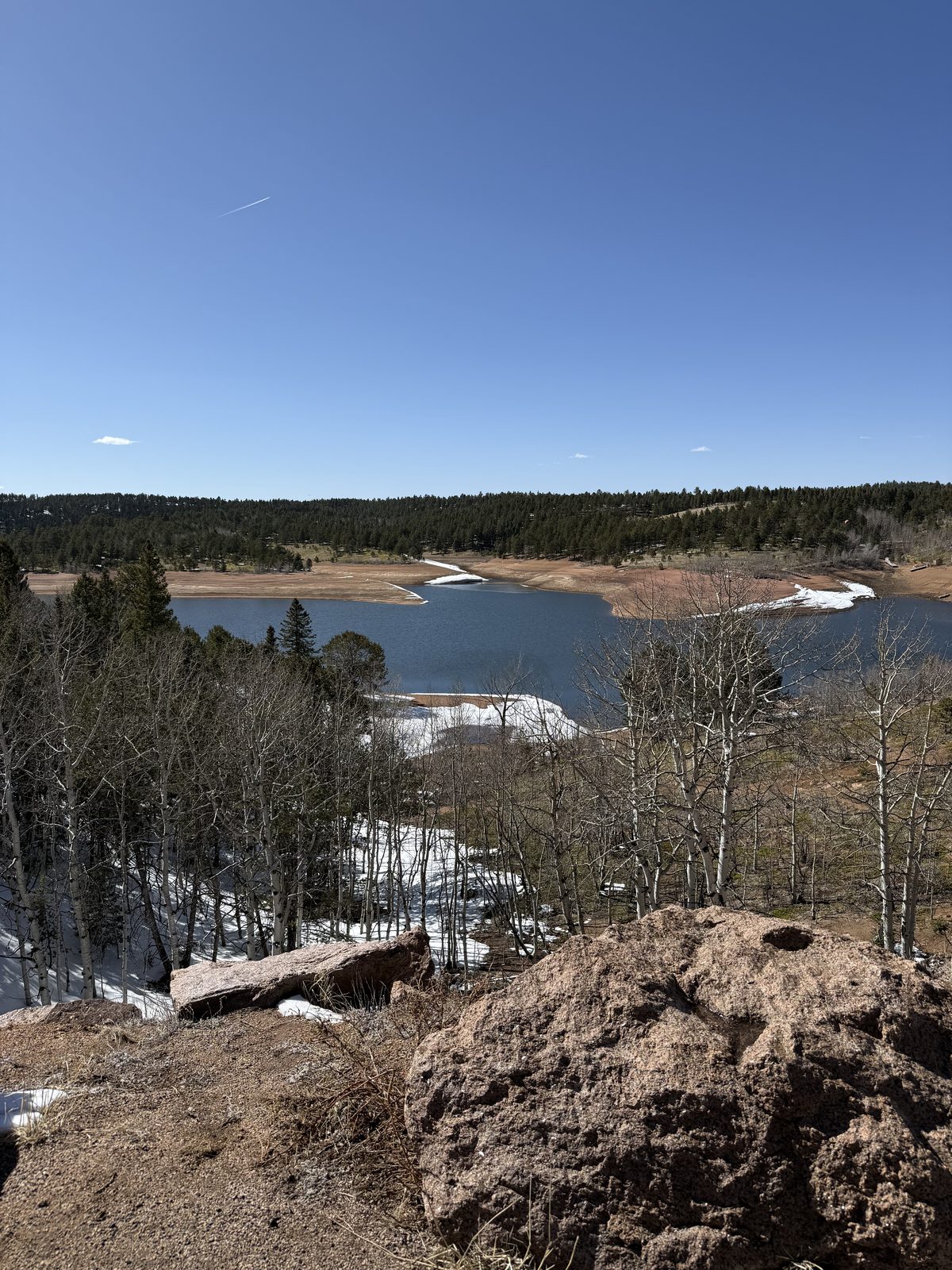 Half-frozen reservoir below the peak